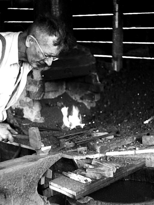 Blacksmith working at an anvil, 1936